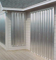 Aluminum storm panels installed over a covered porch opening